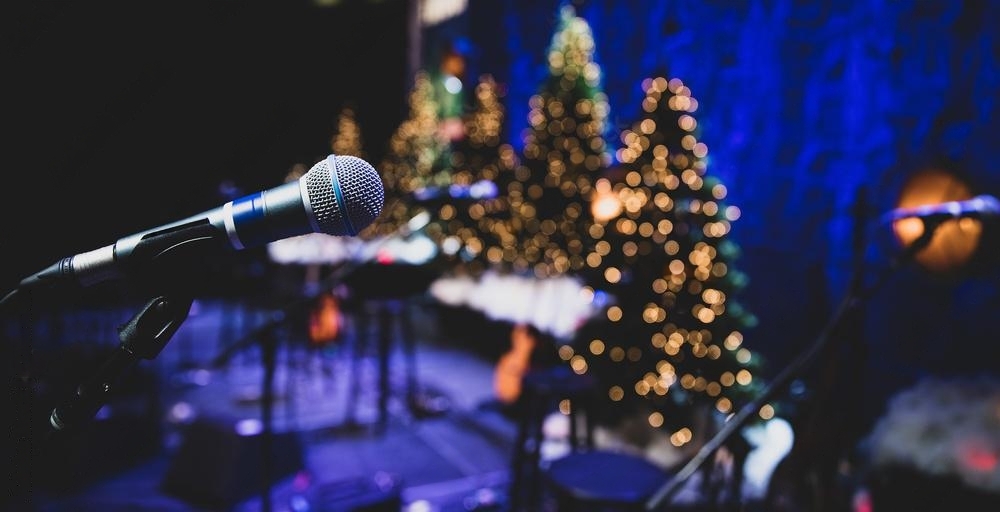 Werknemers die kerstkaraoke zingen en kerstspelletjes spelen tijdens een bedrijfsfeest.